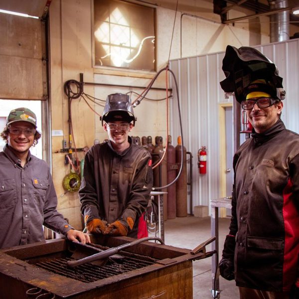 Three men in their protective equipment for welding. | Welding Training
